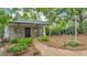 Charming brick playhouse with a shady porch, swing set, and landscaped pathway at 323 E Belvedere St, Lakeland, FL 33803