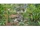 Scenic backyard pond with a small waterfall, rock edging, and lush plantings at 323 E Belvedere St, Lakeland, FL 33803