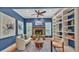 Comfortable sitting room with a stone fireplace, built in shelving, and comfortable seating at 323 E Belvedere St, Lakeland, FL 33803