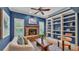 Inviting sitting room features stone fireplace, built-in shelves, and hardwood floors at 323 E Belvedere St, Lakeland, FL 33803