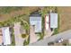 Aerial view of homes, RV Parking, screened patio, and tiki hut at 3243 Red Tail Hawk Dr, Polk City, FL 33868