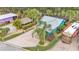 An aerial shot featuring a turquoise home with tiki hut and RV parking at 3243 Red Tail Hawk Dr, Polk City, FL 33868