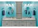 Bright bathroom featuring double sinks with granite countertops and stylish grey cabinets at 3243 Red Tail Hawk Dr, Polk City, FL 33868