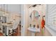 Half bath features a pedestal sink, window and bronze fixtures at 3243 Red Tail Hawk Dr, Polk City, FL 33868