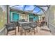 Screened patio features a dining table and comfortable seating, perfect for enjoying the outdoors at 3243 Red Tail Hawk Dr, Polk City, FL 33868