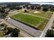 Aerial view of a park with a baseball field, basketball court, parking lot, and soccer field at 355 E Columbia St, Lake Alfred, FL 33850