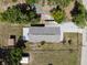 Birds-eye view of home and property showing the roof, sheds, driveway, and mature trees on a large lot at 355 E Columbia St, Lake Alfred, FL 33850