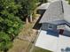 View of fenced-in backyard with concrete patio and lush greenery at 355 E Columbia St, Lake Alfred, FL 33850