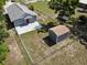 Aerial view of fenced backyard with shed and patio, offering privacy and storage at 355 E Columbia St, Lake Alfred, FL 33850