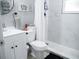 Bright bathroom featuring a modern vanity, toilet, and a shower with beautiful tile work at 355 E Columbia St, Lake Alfred, FL 33850