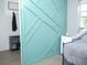 Cozy bedroom with decorative wall paneling and stylish cooling unit at 355 E Columbia St, Lake Alfred, FL 33850