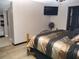 Large bedroom with attached en-suite bathroom and large flat screen TV at 355 E Columbia St, Lake Alfred, FL 33850