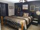 Nicely decorated bedroom with dark walls, ceiling fan, and king sized bed at 355 E Columbia St, Lake Alfred, FL 33850