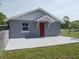 Charming exterior showcasing a well-maintained house, front lawn, and welcoming entryway at 355 E Columbia St, Lake Alfred, FL 33850