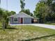 Charming single-story home with a well-maintained lawn and a covered parking area at 355 E Columbia St, Lake Alfred, FL 33850