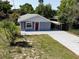 Charming single-story home with a well-maintained lawn and a covered parking area at 355 E Columbia St, Lake Alfred, FL 33850