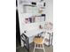 Functional home office with shelves, a white desk, decor and a comfortable chair at 355 E Columbia St, Lake Alfred, FL 33850
