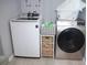 A well-equipped laundry room with modern washer and dryer, plus storage solutions at 355 E Columbia St, Lake Alfred, FL 33850