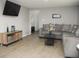 Cozy living room features a modern couch, TV, and stylish decor at 355 E Columbia St, Lake Alfred, FL 33850