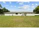 Expansive backyard featuring a well-maintained lawn and neutral-colored exterior of the home at 3810 Harrelson Rd, Lakeland, FL 33810