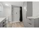 Modern bathroom with stylish shower, gray cabinets and new fixtures at 3810 Harrelson Rd, Lakeland, FL 33810