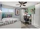 Comfortable bedroom with a soccer theme, featuring a ceiling fan and a functional workspace at 3810 Harrelson Rd, Lakeland, FL 33810
