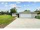 A well-kept home featuring an attached garage and concrete driveway with a yard at 3810 Harrelson Rd, Lakeland, FL 33810