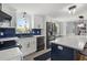 Bright kitchen featuring stainless steel appliances, white cabinets, and a dark blue tile backsplash at 3810 Harrelson Rd, Lakeland, FL 33810