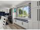 Bright eat-in kitchen with white cabinets, built-in bench seating, and stainless steel appliances at 3810 Harrelson Rd, Lakeland, FL 33810
