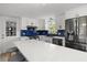 Modern kitchen featuring white cabinets, stainless steel appliances, and a blue backsplash at 3810 Harrelson Rd, Lakeland, FL 33810
