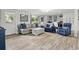 Cozy living room with hardwood floors, blue accent furniture, and plenty of natural light at 3810 Harrelson Rd, Lakeland, FL 33810