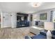Cozy living room featuring stylish furniture, modern TV console, and light wood flooring at 3810 Harrelson Rd, Lakeland, FL 33810