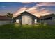 Home featuring a spacious fenced backyard and an enclosed patio, perfect for outdoor living and entertaining at 420 Sir Phillips Dr, Davenport, FL 33837
