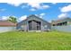 Well-maintained backyard featuring privacy fence, green grass, and rear of the home at 420 Sir Phillips Dr, Davenport, FL 33837