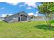 Expansive backyard with green grass surrounds this well-maintained home at 420 Sir Phillips Dr, Davenport, FL 33837