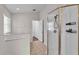 Bright bathroom with a step-up tub, glass shower, and neutral tiling at 420 Sir Phillips Dr, Davenport, FL 33837