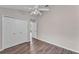 Bedroom featuring modern flooring, white closet, and lots of light coming from the hallway at 420 Sir Phillips Dr, Davenport, FL 33837
