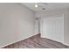 Bedroom with wood-look flooring, neutral paint, standard closet, and ceiling fan at 420 Sir Phillips Dr, Davenport, FL 33837