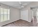 Bright bedroom with neutral paint, wood-look flooring, and a window with verdant views at 420 Sir Phillips Dr, Davenport, FL 33837