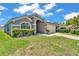 Inviting single-story home featuring a well-kept lawn, neutral colors, and an attached two-car garage at 420 Sir Phillips Dr, Davenport, FL 33837