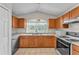 Efficient kitchen featuring light wood cabinets, tile flooring, and modern appliances at 420 Sir Phillips Dr, Davenport, FL 33837
