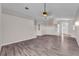 Open-concept living room featuring wood-look flooring, vaulted ceilings, and neutral walls at 420 Sir Phillips Dr, Davenport, FL 33837