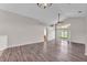 Bright living room featuring wood-look flooring, neutral paint, and sliding glass doors to the outdoor space at 420 Sir Phillips Dr, Davenport, FL 33837