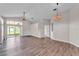 Spacious living room with wood-look flooring and vaulted ceilings at 420 Sir Phillips Dr, Davenport, FL 33837