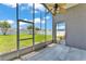 Screened-in porch with tile floors overlooks the green backyard and fence at 420 Sir Phillips Dr, Davenport, FL 33837