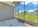 View from the screened-in porch shows backyard, blue sky, and a ceiling fan at 420 Sir Phillips Dr, Davenport, FL 33837
