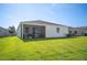 Exterior view of home with a screened patio and spacious backyard at 4303 Moon Shadow Loop, Mulberry, FL 33860