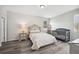 Cozy bedroom with neutral colors, hardwood flooring, and a crib, perfect for a young Gathering at 4303 Moon Shadow Loop, Mulberry, FL 33860