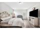 Comfortable bedroom with neutral colors and hardwood flooring features a crib and ample natural light at 4303 Moon Shadow Loop, Mulberry, FL 33860