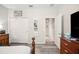 Stylish bedroom showcasing modern gray wood-look floors and ample closet space at 4303 Moon Shadow Loop, Mulberry, FL 33860